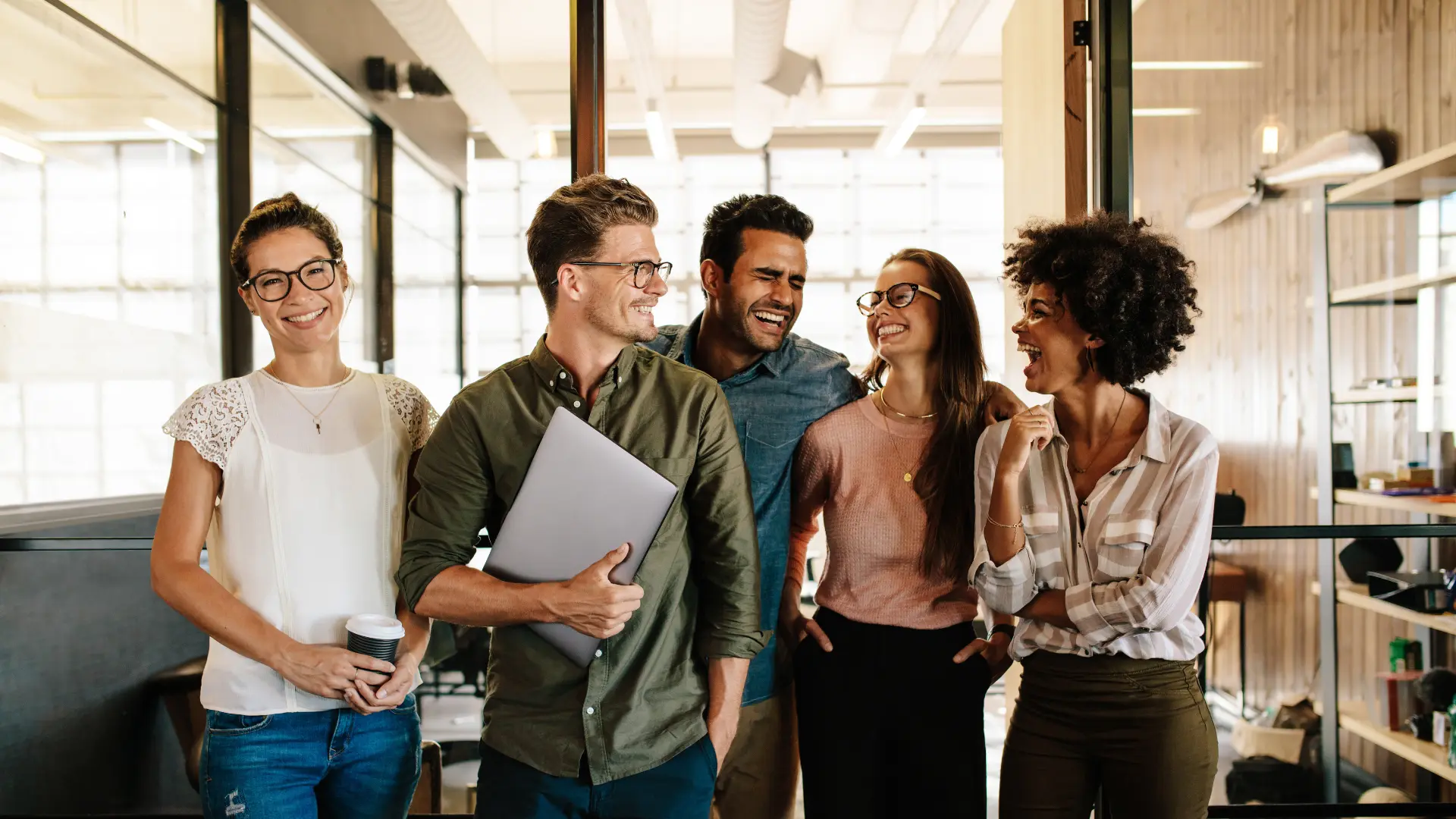 Colleagues smiling to each other in their workplace